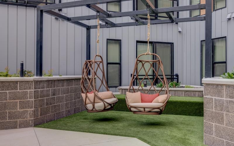 a chair and a swing set outside