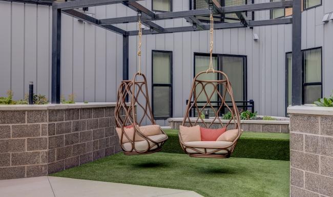 a chair and a swing set outside
