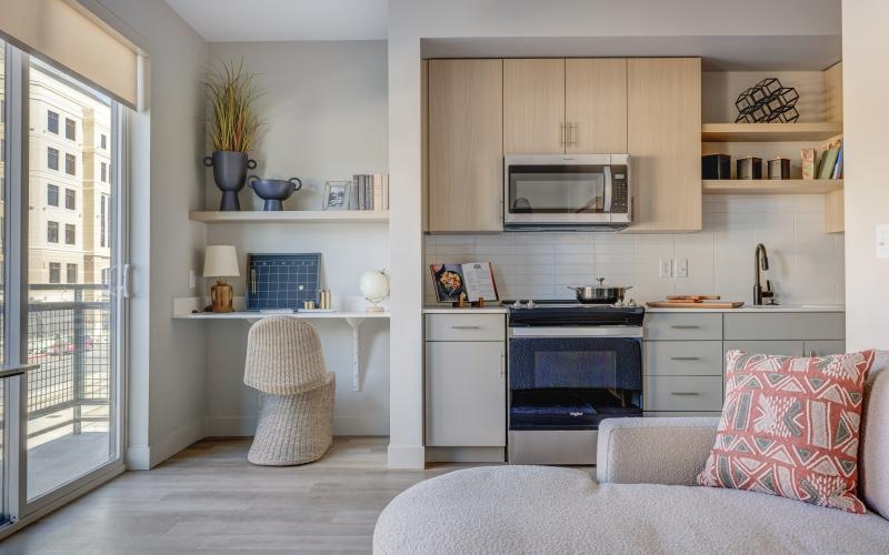 a kitchen with a couch and a microwave