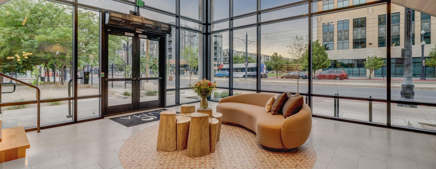 a large room with a large glass wall and a large round rug